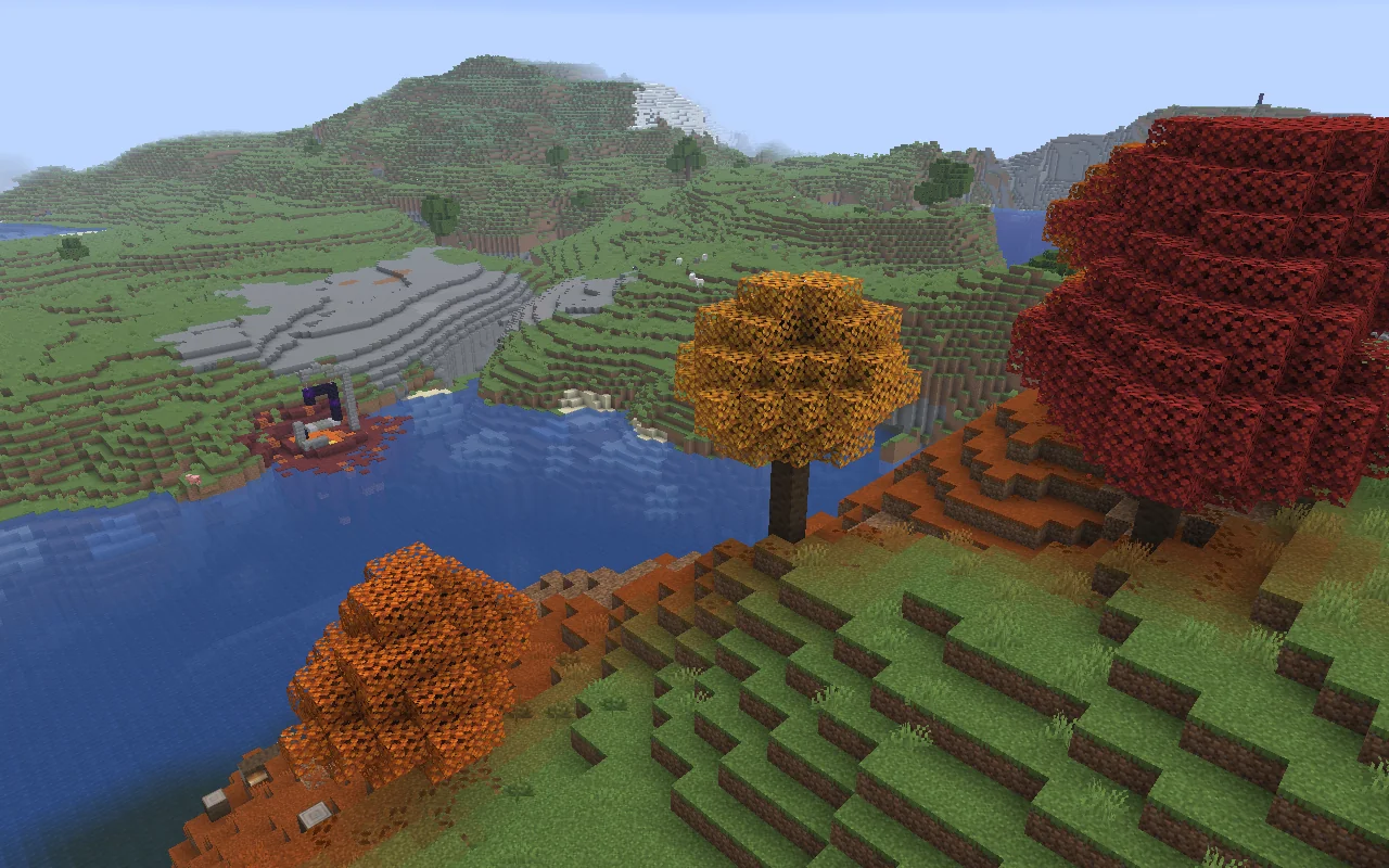 Red, yellow, and orange poplar trees on a Dappled Forest hillside above the water.
