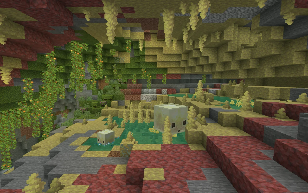 Two sulfur cubes above turquoise pools in a cavern with sulfur spikes and hanging vines in Minecraft 26.2.